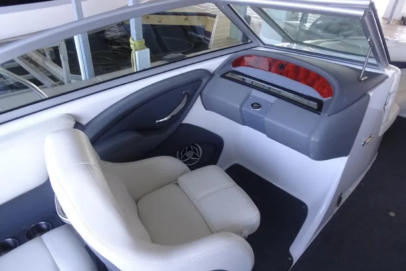 Slide: The Image of Interior of a 2008 Cobalt 232 boat with white seating and dashboard. - 12