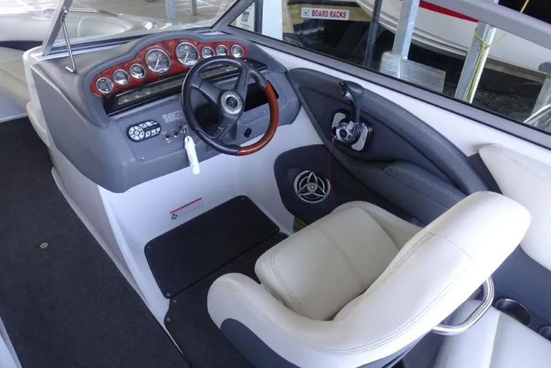 Slide: The Image of Interior of a 2008 Cobalt 232 boat, featuring steering wheel and dashboard controls. - 13