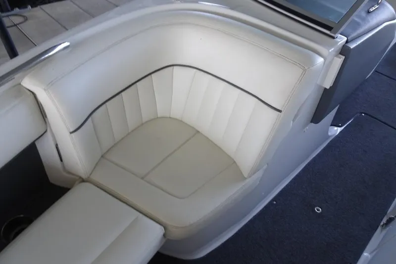 Slide: The Image of 2008 Cobalt 232 boat interior with white leather seating and sleek design. - 17