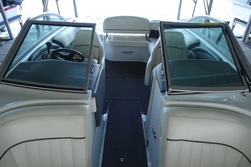 Slide: The Image of Interior view of a 2008 Cobalt 232 boat with white seating and dual windshields. - 18