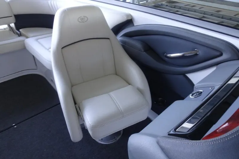Slide: The Image of 2008 Cobalt 232 boat interior with white captain's chair and sleek design. - 19