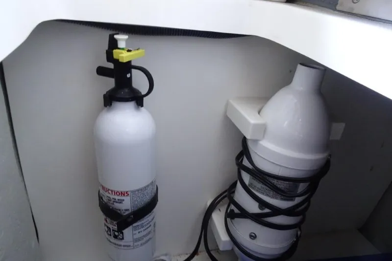 Slide: The Image of Fire extinguisher and safety equipment in 2008 Cobalt 232 boat interior. - 23