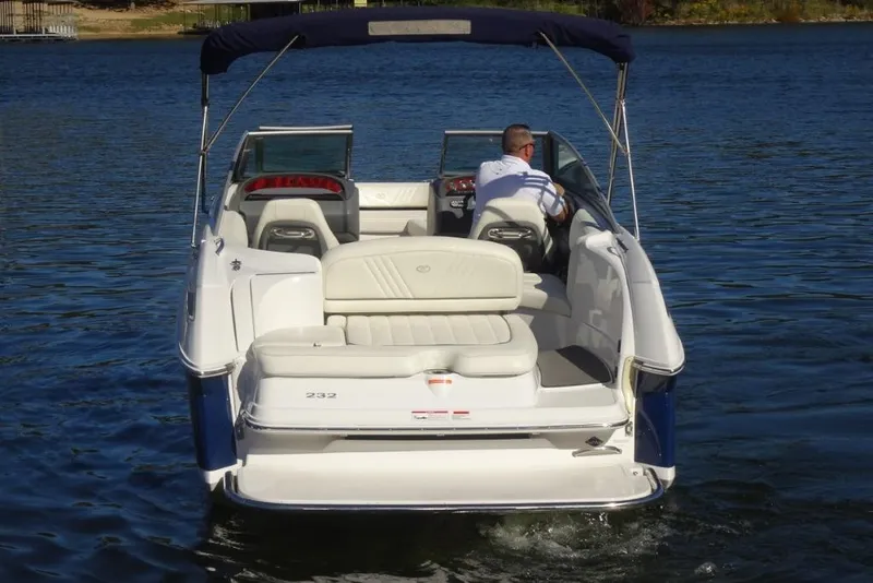 Slide: The Image of 2008 Cobalt 232 boat cruising on a calm lake, rear view. - 3