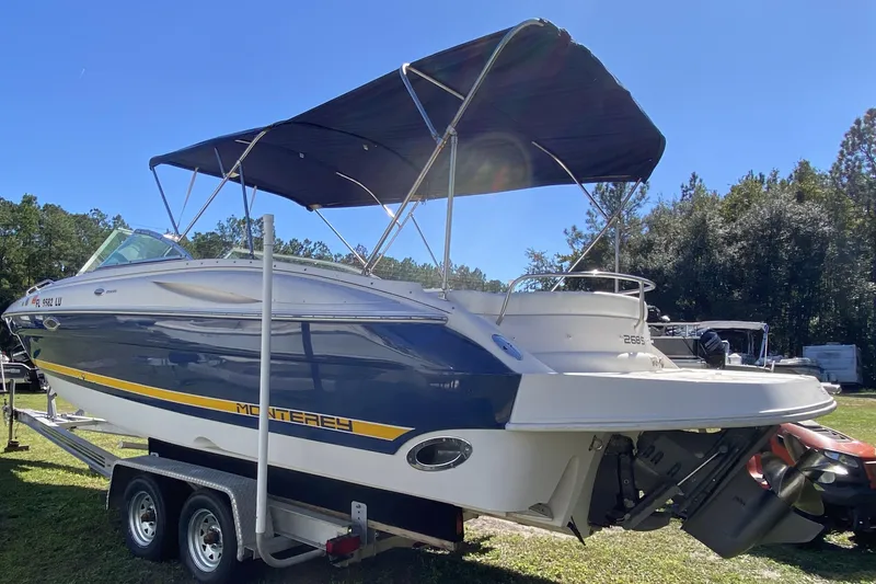 The Image of 2002 Monterey 268SS Super Sport boat on trailer, blue and white with canopy. - 1