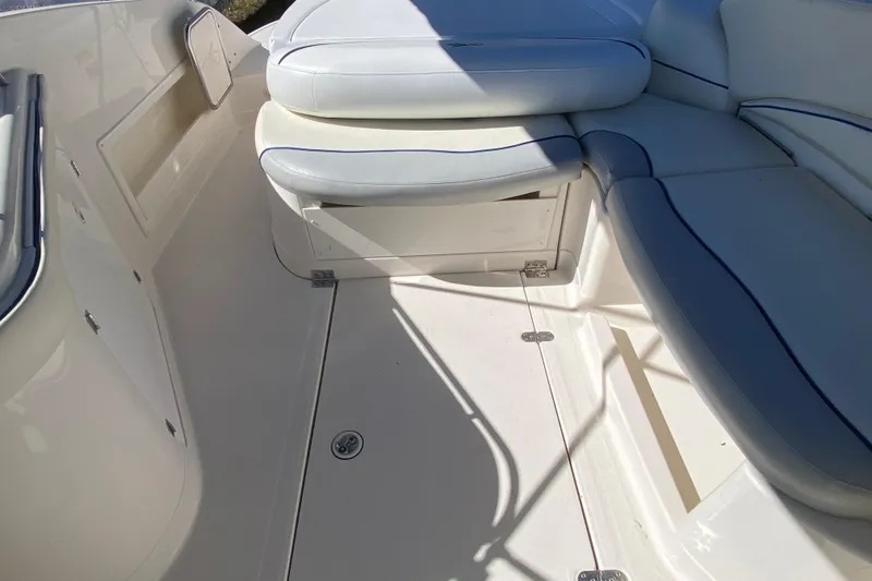 Slide: The Image of 2002 Monterey 268SS Super Sport boat interior with white cushioned seating. - 10
