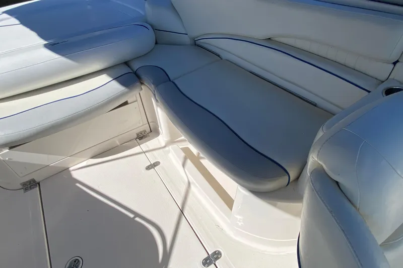 Slide: The Image of 2002 Monterey 268SS Super Sport boat interior with white and blue cushioned seating. - 11