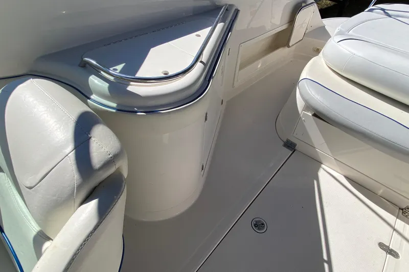 Slide: The Image of Interior of a 2002 Monterey 268SS Super Sport boat with white seating and chrome accents. - 12