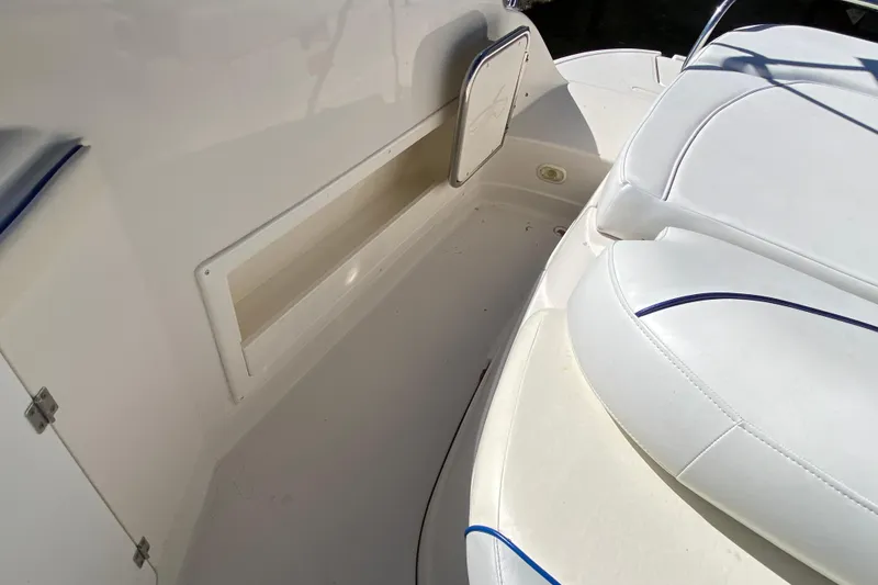Slide: The Image of 2002 Monterey 268SS Super Sport boat interior with white seating and storage compartment. - 15
