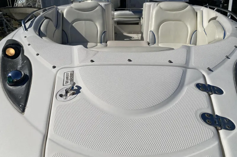 Slide: The Image of 2002 Monterey 268SS Super Sport boat interior with white seating and deck details. - 23