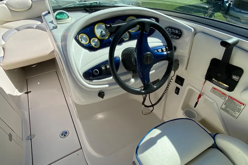 Slide: The Image of Interior view of a 2002 Monterey 268SS Super Sport boat dashboard and steering wheel. - 5
