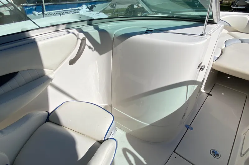 Slide: The Image of 2002 Monterey 268SS Super Sport boat interior with white seating and sleek design. - 6