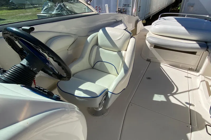 Slide: The Image of Interior of a 2002 Monterey 268SS Super Sport boat, featuring white seating and steering wheel. - 9