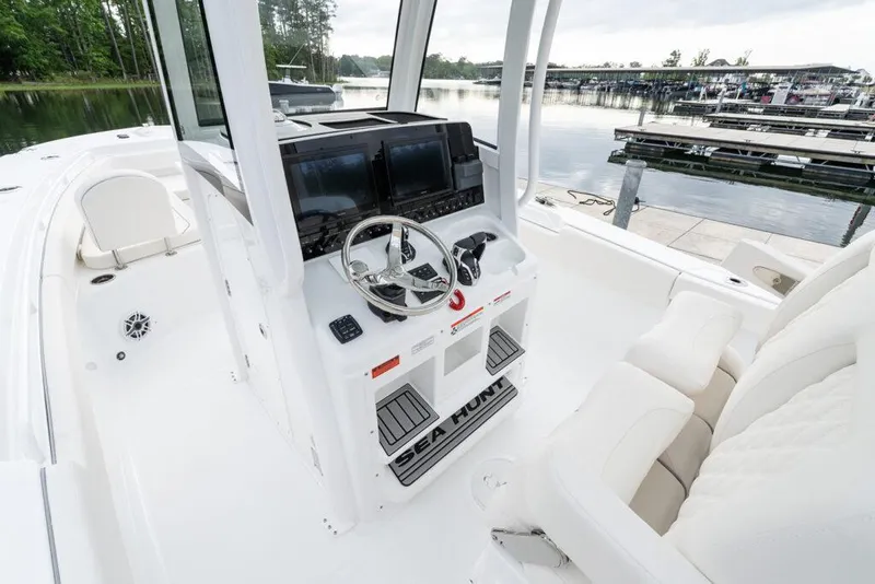Slide: The Image of Manufacturer Provided Image: 2026 Sea Hunt Gamefish 27 boat interior with forward seating and modern helm controls. - 7