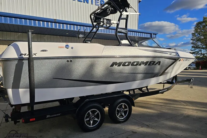 Slide: The Image of 2020 Moomba Max boat on trailer, parked outdoors under a blue sky. - 10