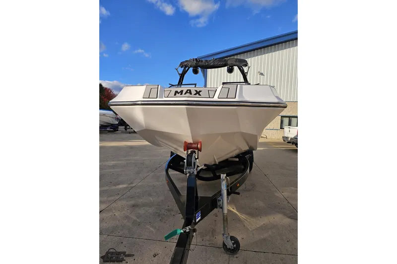 Slide: The Image of 2020 Moomba Max boat on trailer, parked outdoors under a clear blue sky. - 19