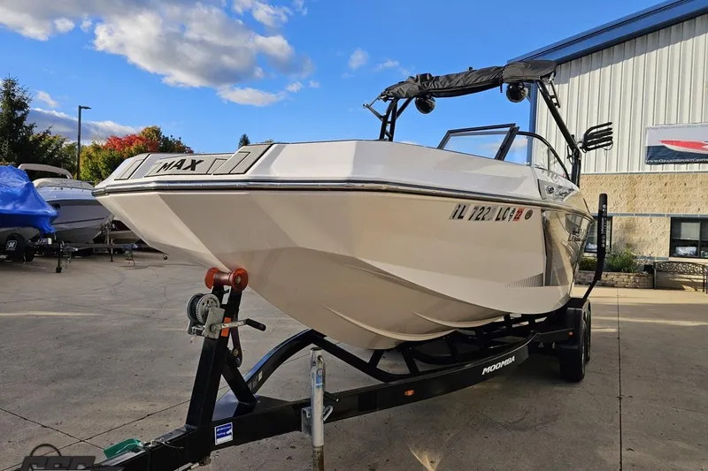 Slide: The Image of 2020 Moomba Max boat on trailer, parked outdoors under a clear sky. - 20