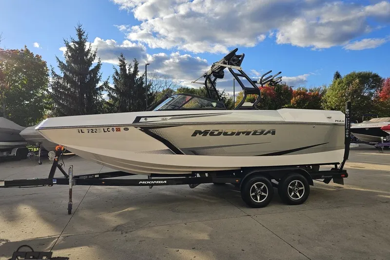 Slide: The Image of 2020 Moomba Max boat on trailer under a partly cloudy sky. - 22