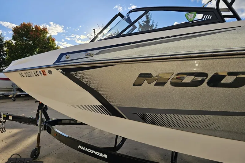 Slide: The Image of 2020 Moomba Max boat on trailer, sleek design under a clear sky. - 25