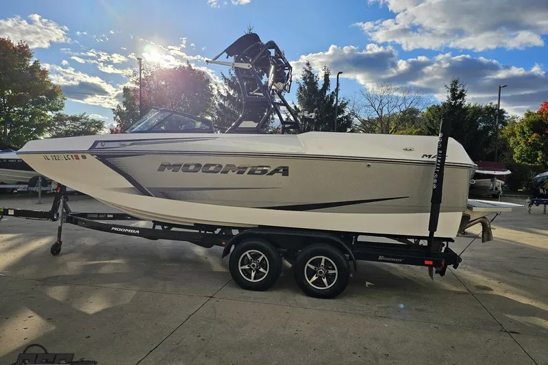 Slide: The Image of 2020 Moomba Max boat on trailer under a partly cloudy sky. - 29
