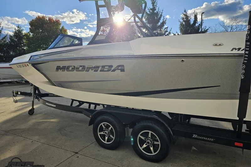 Slide: The Image of 2020 Moomba Max boat on trailer under sunny sky, showcasing sleek design. - 30