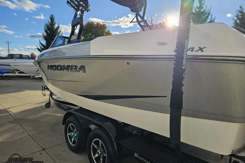 Slide: The Image of 2020 Moomba Max boat on trailer, parked outdoors under a sunny sky. - 31