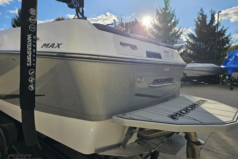 Slide: The Image of 2020 Moomba Max boat with Raptor engine, parked outdoors under a sunny sky. - 32