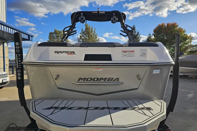 Slide: The Image of 2020 Moomba Max boat with Raptor engine, parked outdoors under a partly cloudy sky. - 34