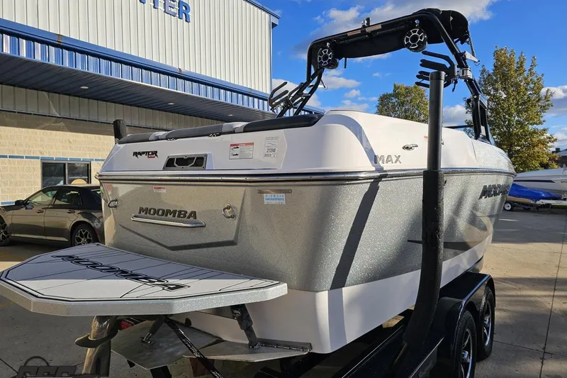 Slide: The Image of 2020 Moomba Max boat with Raptor engine, parked outdoors on a sunny day. - 37