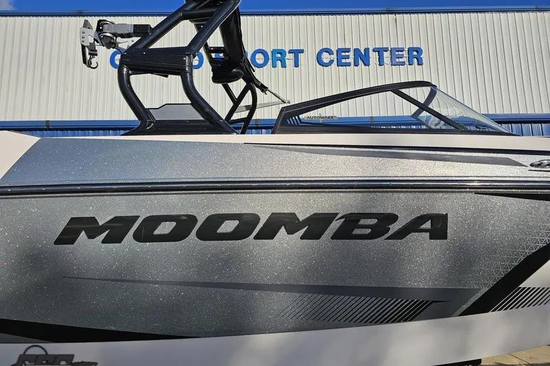 Slide: The Image of 2020 Moomba Max boat at dealership, showcasing sleek design and branding. - 4