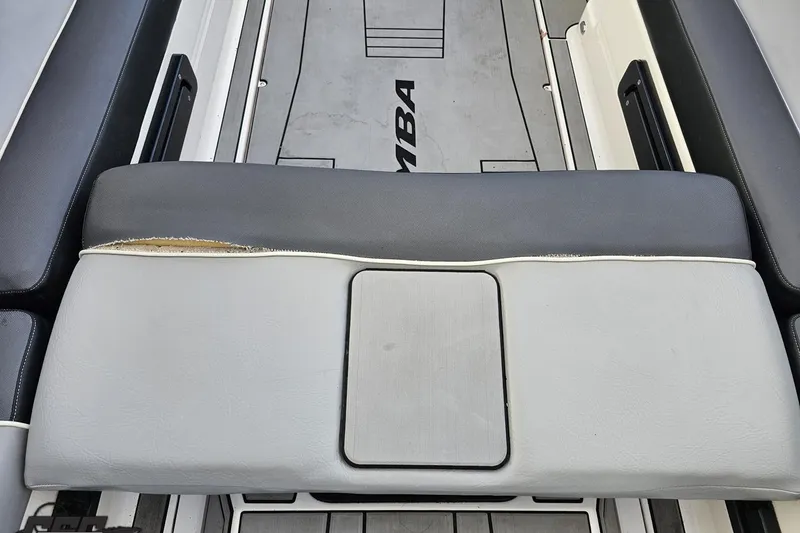 Slide: The Image of 2020 Moomba Max boat interior with worn seat upholstery and visible logo. - 47