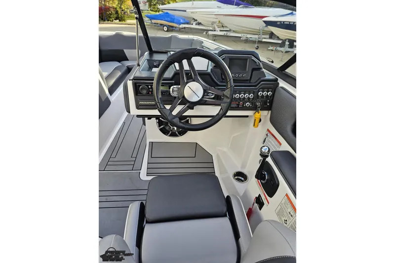 Slide: The Image of 2020 Moomba Max boat cockpit with steering wheel and control panel. - 56