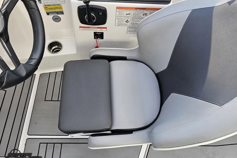 Slide: The Image of 2020 Moomba Max boat interior with steering wheel and cushioned seat. - 57