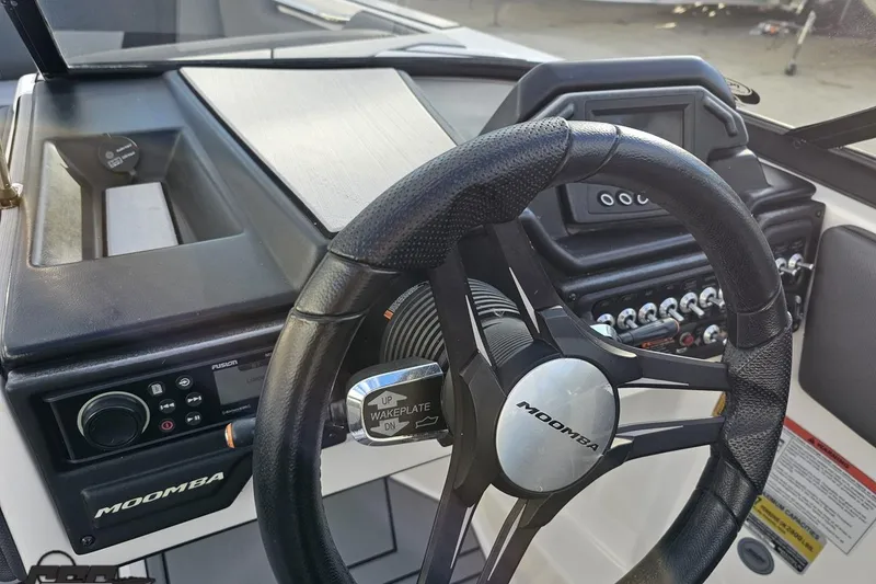 Slide: The Image of 2020 Moomba Max boat dashboard with steering wheel and control panel. - 59