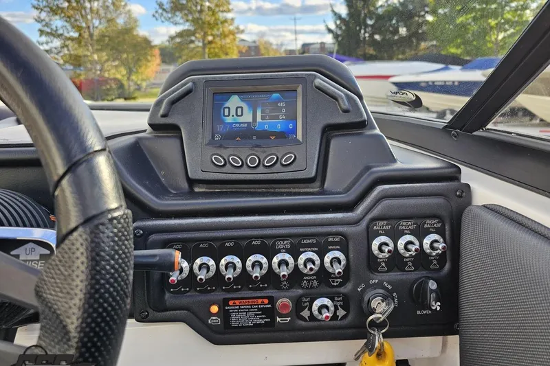 Slide: The Image of Dashboard of a 2020 Moomba Max boat with control panel and display screen. - 62
