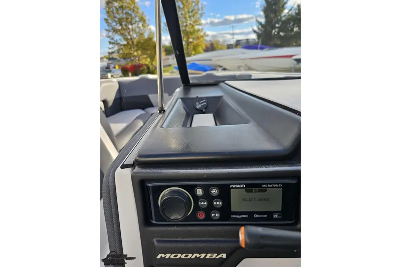 Slide: The Image of 2020 Moomba Max boat dashboard with Fusion stereo system and outdoor view. - 64