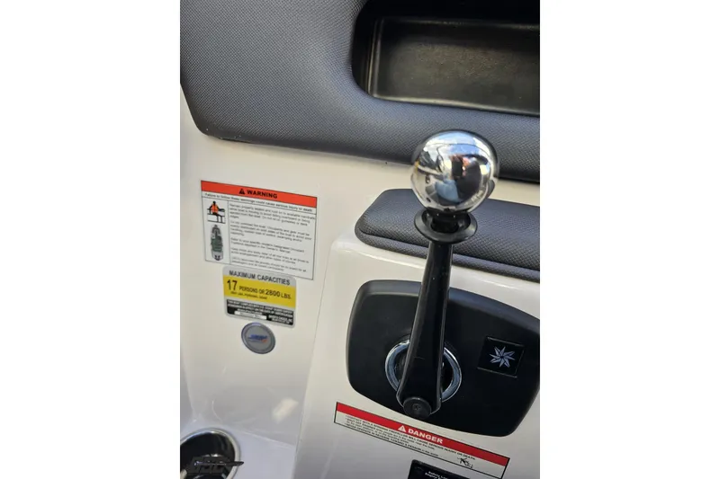 Slide: The Image of 2020 Moomba Max boat control panel with gear lever and safety warnings. - 65