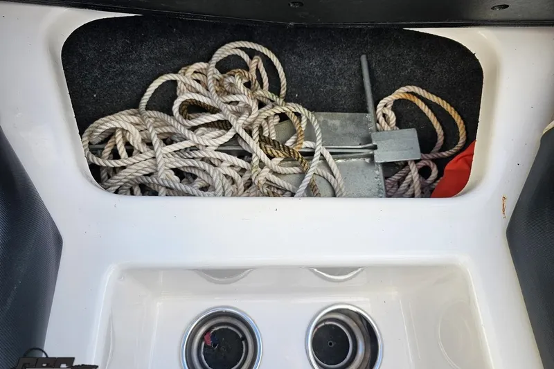 Slide: The Image of Storage compartment in a 2020 Moomba Max boat with rope and anchor. - 79