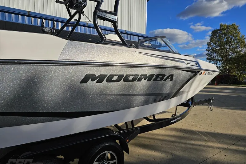 Slide: The Image of 2020 Moomba Max boat on trailer, parked outdoors under blue sky. - 9