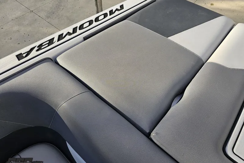 Slide: The Image of 2020 Moomba Max boat interior with gray cushioned seating. - 92