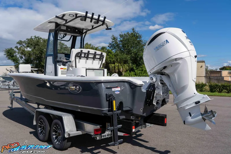 Slide: The Image of 2026 Sea Hunt BX 25 FS boat on trailer with Yamaha outboard motor, parked outdoors. - 11