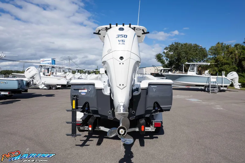 Slide: The Image of 2026 Sea Hunt BX 25 FS boat with powerful 350 V6 engine at a marina. - 12