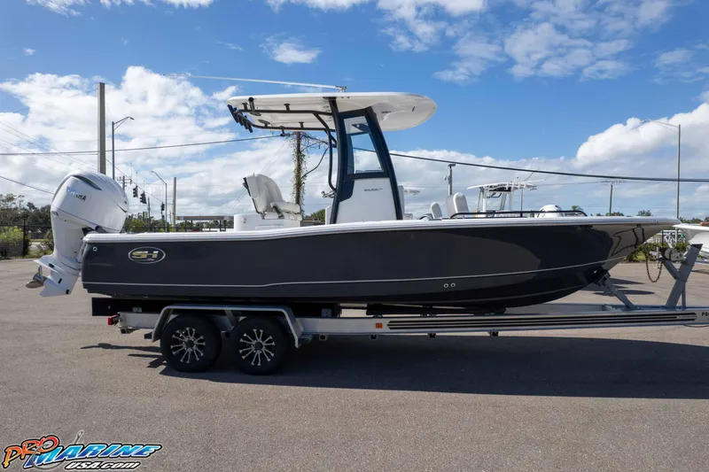 Slide: The Image of 2026 Sea Hunt BX 25 FS boat on trailer under clear blue sky. - 20