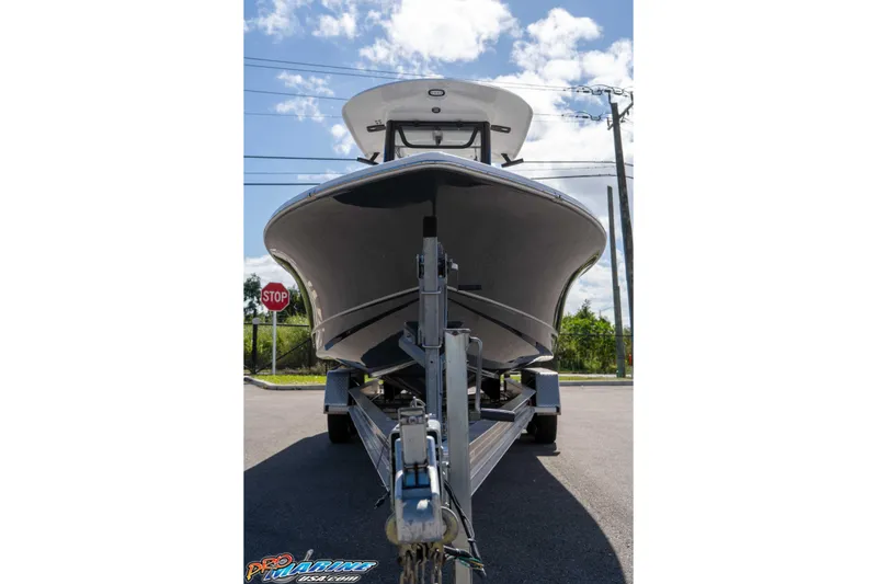 Slide: The Image of 2026 Sea Hunt BX 25 FS boat on trailer, viewed from front, under a clear sky. - 21