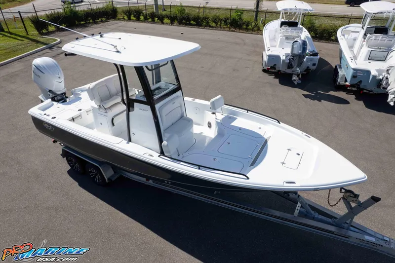 Slide: The Image of 2026 Sea Hunt BX 25 FS boat on trailer, parked outdoors, side view. - 26