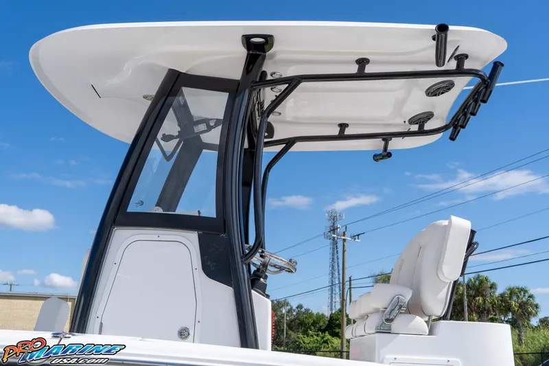 Slide: The Image of 2026 Sea Hunt BX 25 FS boat with T-top and seating, under clear blue sky. - 27