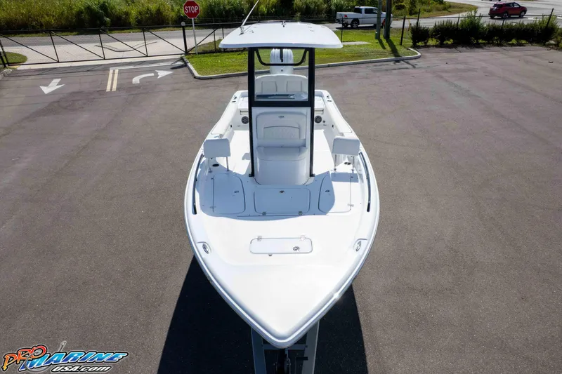 Slide: The Image of 2026 Sea Hunt BX 25 FS boat, aerial view, parked on asphalt, showcasing sleek design. - 30