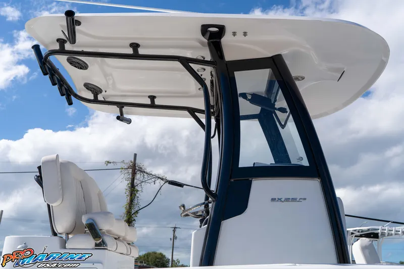 Slide: The Image of 2026 Sea Hunt BX 25 FS boat console with T-top against a cloudy sky. - 31