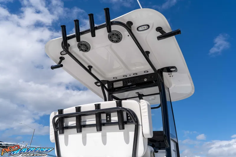 Slide: The Image of 2026 Sea Hunt BX 25 FS boat with T-top and rod holders against blue sky. - 33