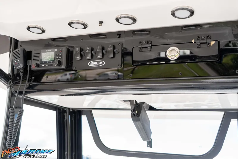 Slide: The Image of 2026 Sea Hunt BX 25 FS boat console with Garmin radio and control switches. - 46