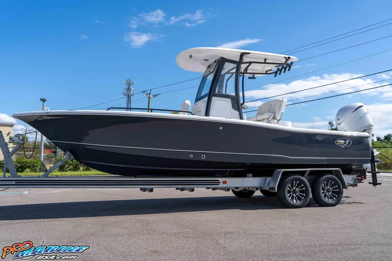 Slide: The Image of 2026 Sea Hunt BX 25 FS boat on trailer under clear blue sky. - 5